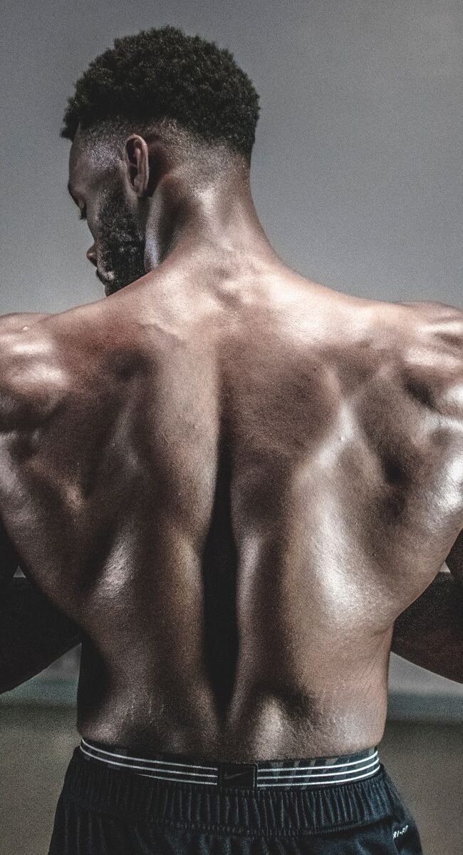 A shirtless man displaying his muscular back, showcasing strength and fitness.