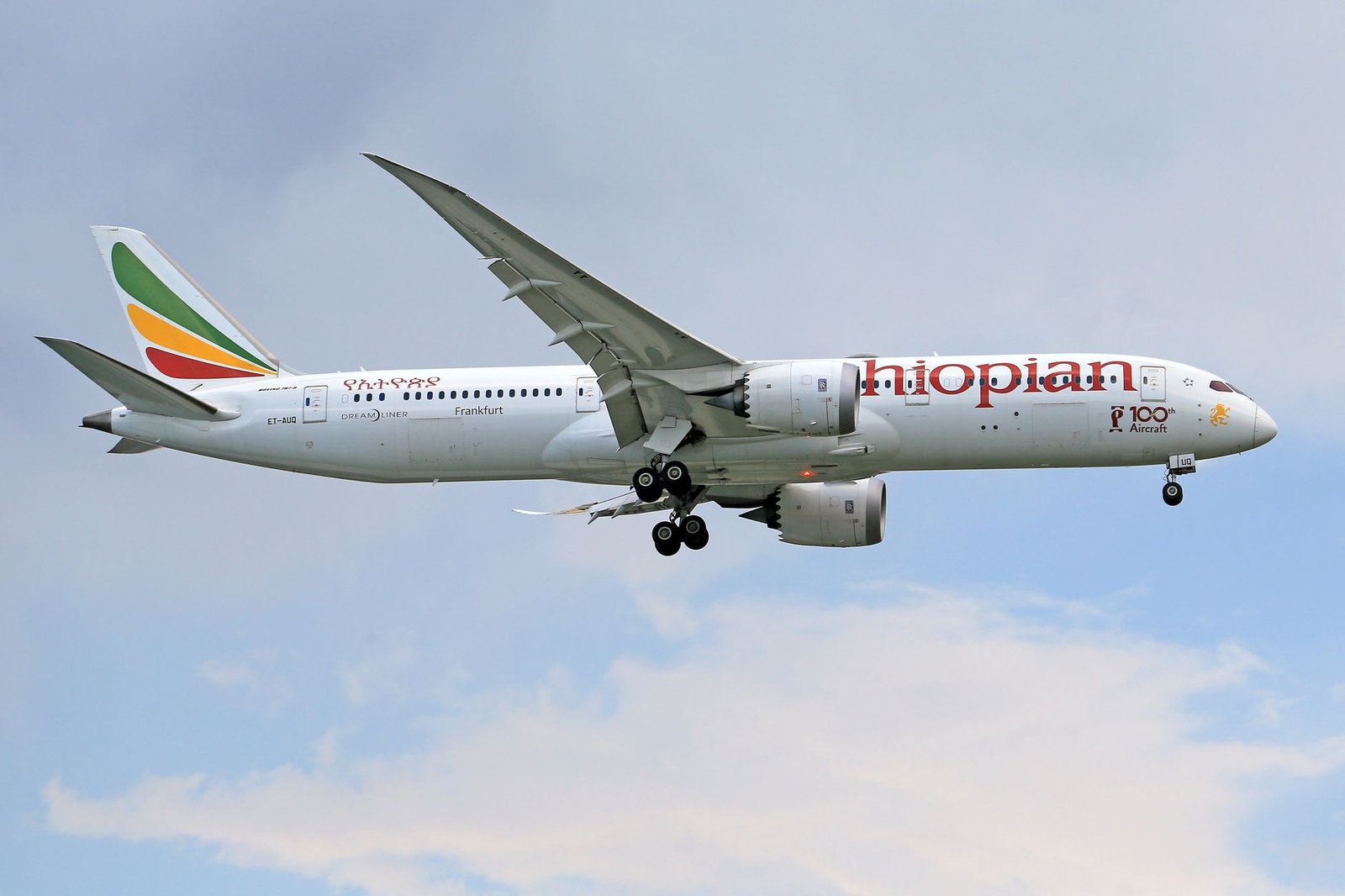 Ethiopian Airlines Boeing 787 Dreamliner in flight against a clear sky.